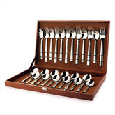 24-piece silver cutlery set with textured handles neatly arranged inside an open brown storage box.